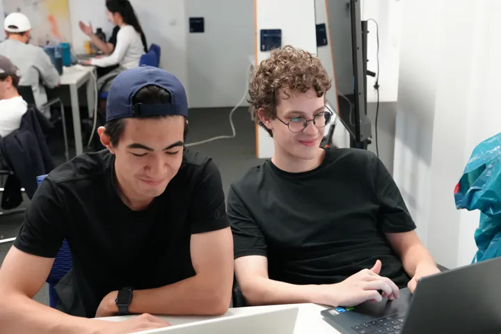Two participants pairing on a laptop